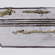The tube-like structures embedded within the rock.